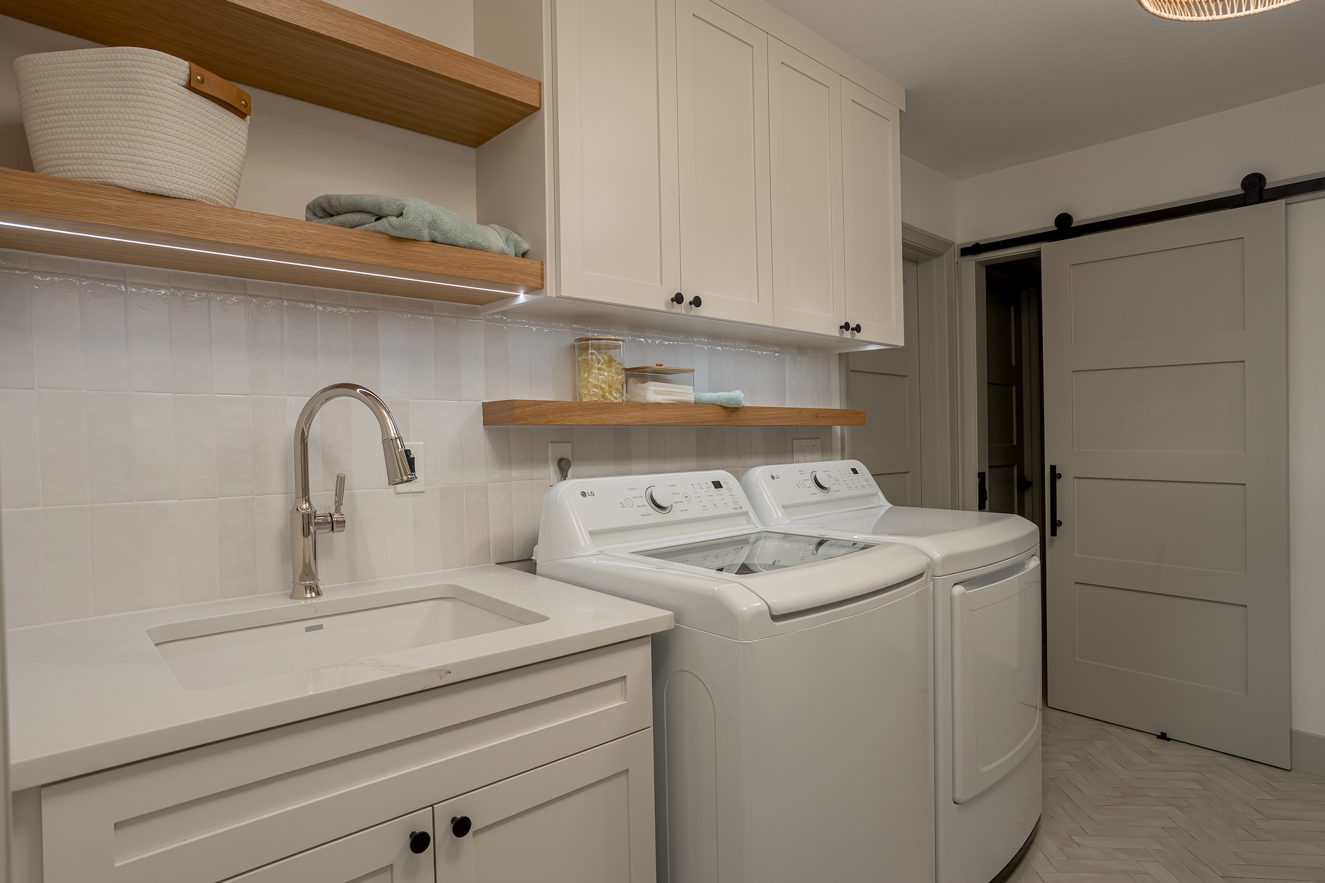 Gorgeous, remodeled laundry room with custom cabinetry and high end finishes